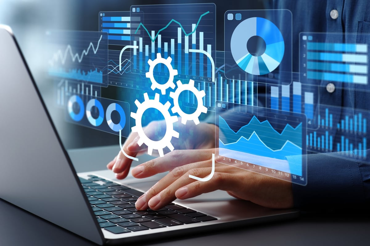 Automated reporting and business intelligence. Data automation and dashboards. Businessman using laptop computer to generate and monitor real-time reports.